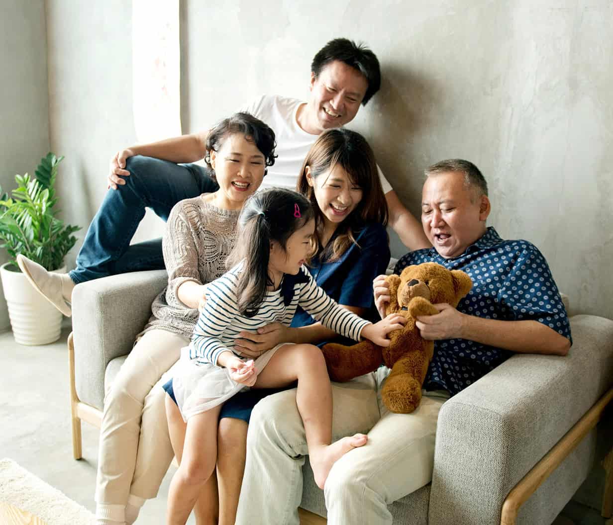 Happy family sitting on a couch in their new home